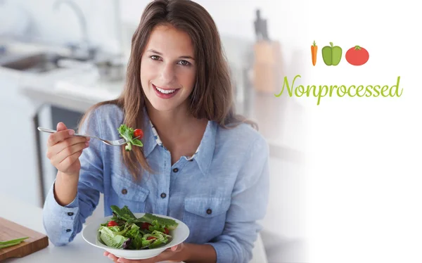 Nonprocessed against pretty woman eating a salad — Stock Photo, Image