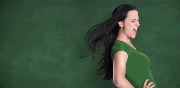 Samengestelde afbeelding van brunette in groene tshirt — Stockfoto