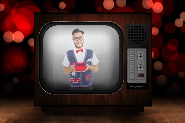 Geeky hipster offering christmas gift — Stock Photo, Image