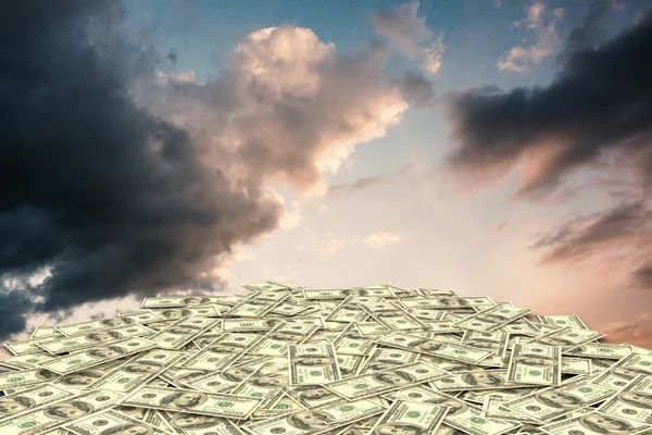 Dollars against blue and orange sky — Stock Photo, Image