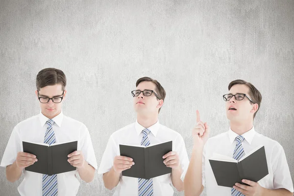 Composite image of nerd reading book — Stock Photo, Image