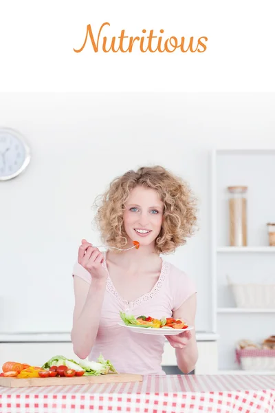 Blonde woman eating some vegetables — Stock Photo, Image