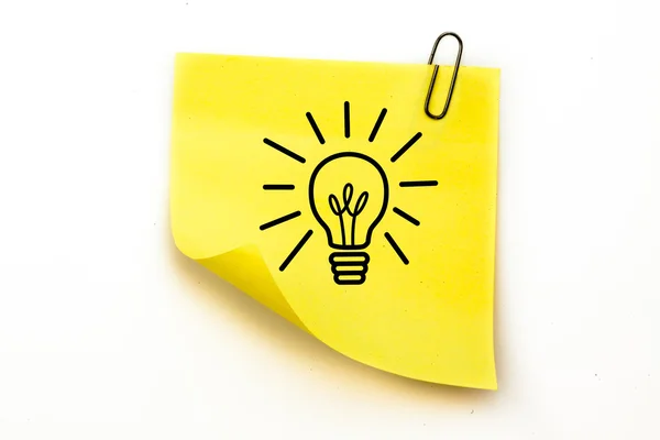 Light bulb against sticky note — Stock Photo, Image