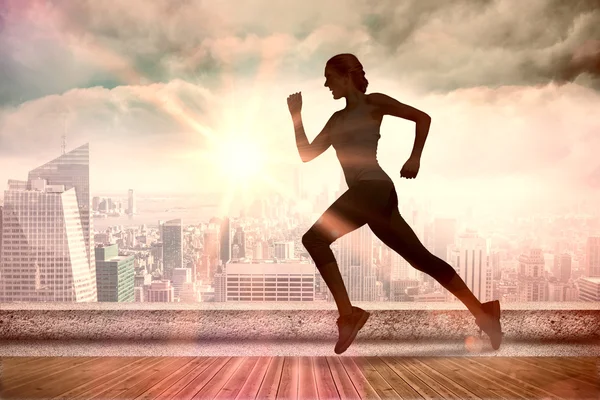 Samengestelde afbeelding van vrij fit blonde joggen — Stockfoto