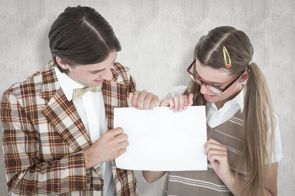 Geeky hipsters holding a poster — Stock Photo, Image