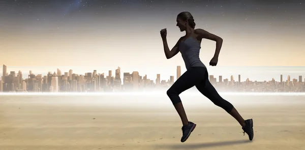 Composite image of pretty fit blonde jogging — Stock Photo, Image