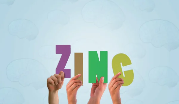 Composite image of hands holding up zinc — Stock Photo, Image