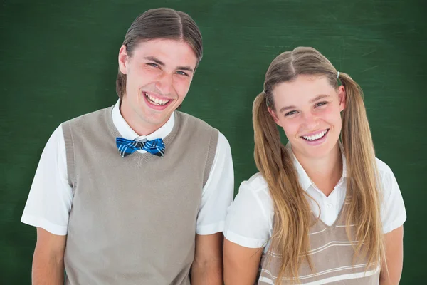 Smiling geeky hipsters looking at camera — Stock Photo, Image