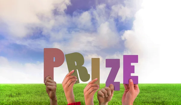 Composite image of hands holding up prize — Stock Photo, Image