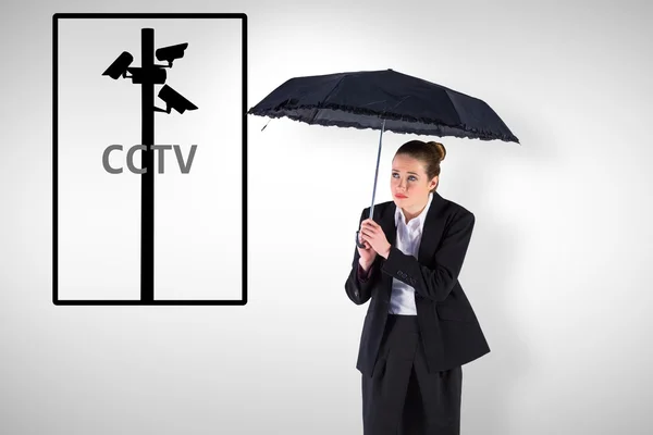 Businesswoman holding a black umbrella — Stock Photo, Image