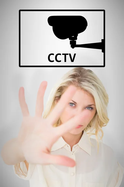 Pretty blonde holding hand up to camera — Stock Photo, Image
