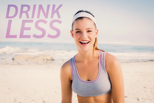 Sporty blonde on the beach smiling — Stock Photo, Image