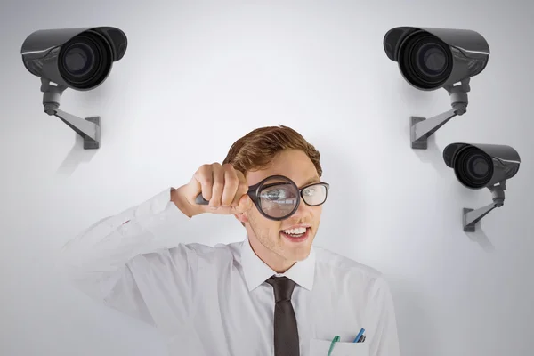 Businessman looking through magnifying glass — Stock Photo, Image