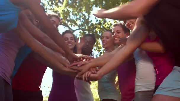 Fitness group putting hands together — Stock Video