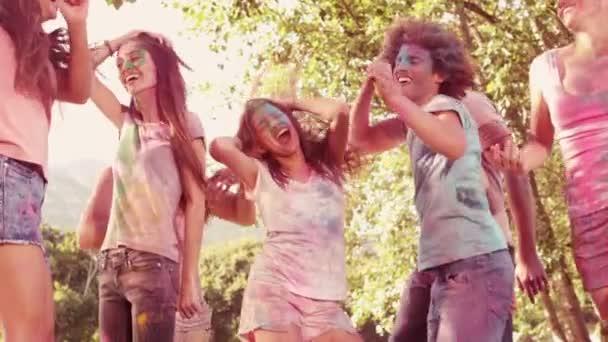 В замедленной съемке счастливые друзья покрыты порошковой краской — стоковое видео