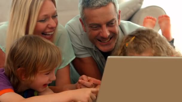 Happy family using laptop together — Stock Video