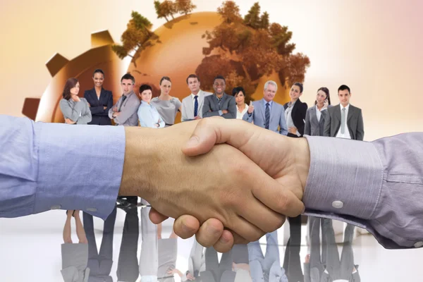 Composite image of hand shake in front of wires — Stock Photo, Image