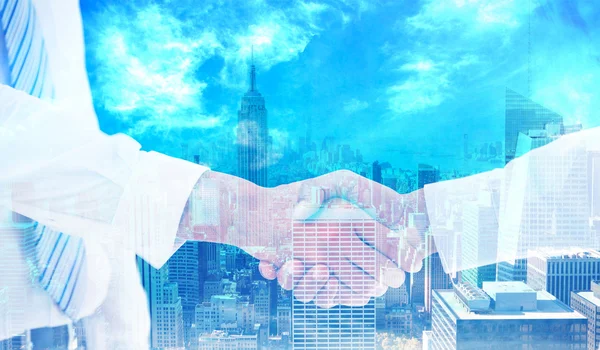 Handshake in office against city skyline — Stock Photo, Image