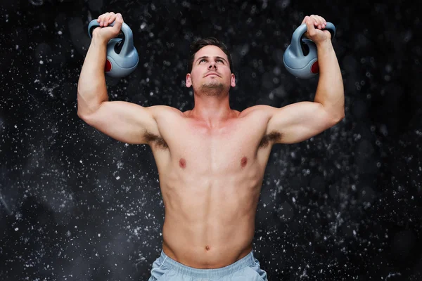 Bodybuilder holding kettlebells — Stock Photo, Image
