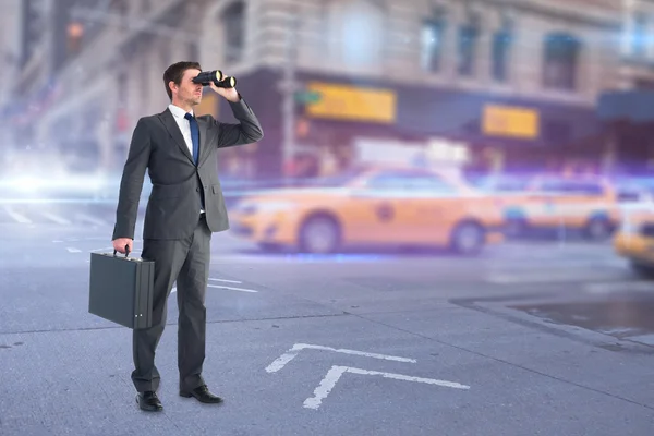 Businessman looking through binoculars — Stock Photo, Image