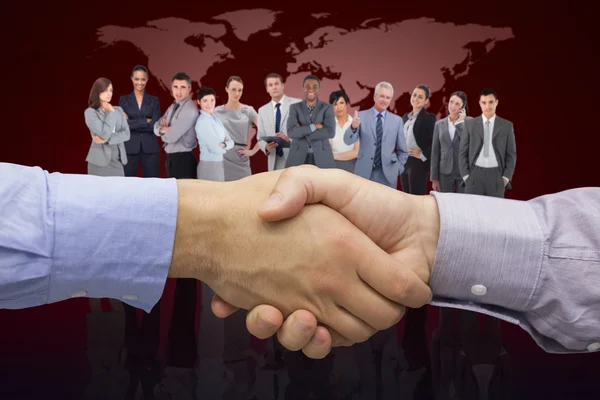 Composite image of hand shake in front of wires — Stock Photo, Image