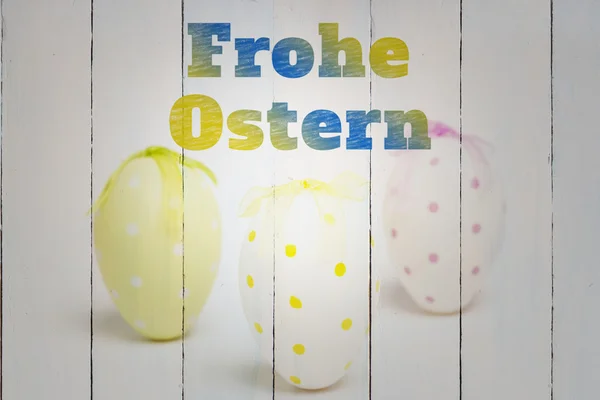 Frohe ostern against three easter eggs — Stock Photo, Image