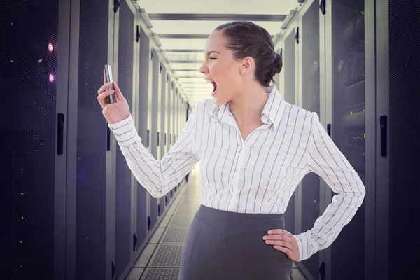 Angry businesswoman screaming at her phone — Stock Photo, Image