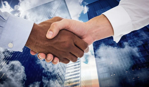 Handshake in office against skyscrapers — Stock Photo, Image