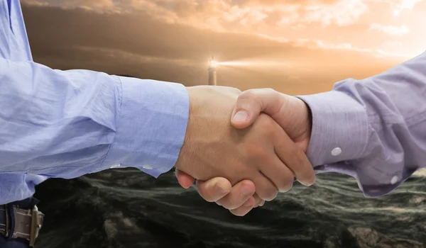 Composite image of two men shaking hands — Stock Photo, Image