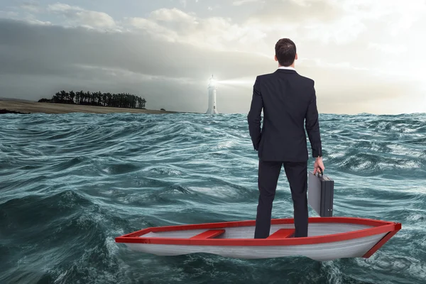 Businessman in boat against stormy se — Stock Photo, Image