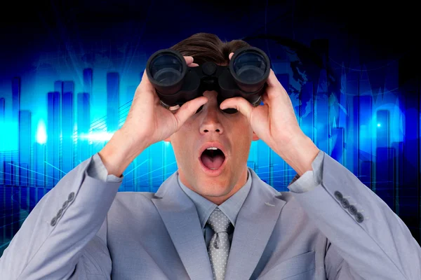 Suprised businessman looking through binoculars — Stock Photo, Image