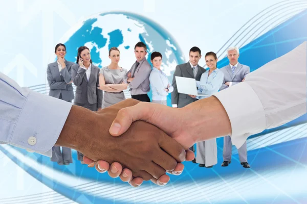 Composite image of close-up shot of a handshake in office — Stock Photo, Image