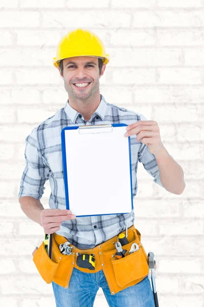 Confident carpenter holding clip board — Stock Photo, Image