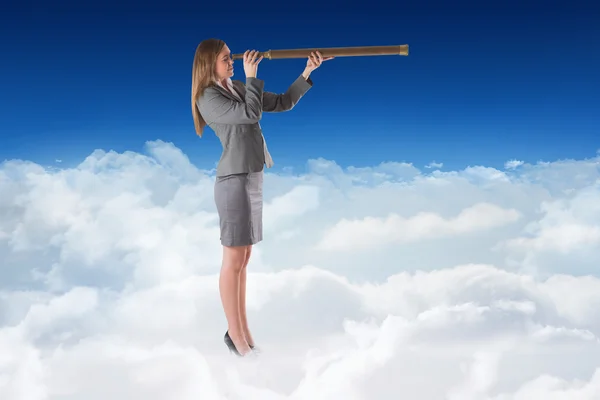 Businesswoman looking through a telescope — Stock Photo, Image