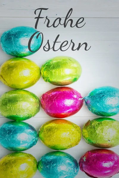 Frohe ostern against many easter eggs — Stock Photo, Image