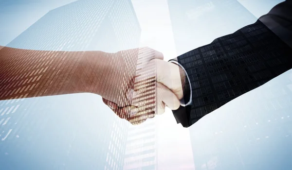 Handshake against of skyscrapers — Stock Photo, Image