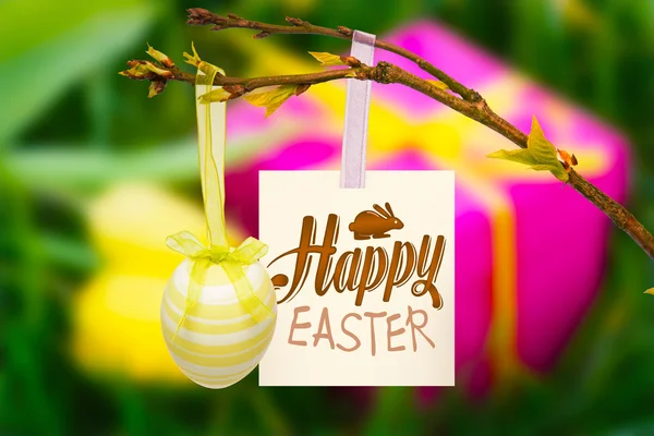 Happy easter graphic against gift box and tulips — Stock Photo, Image