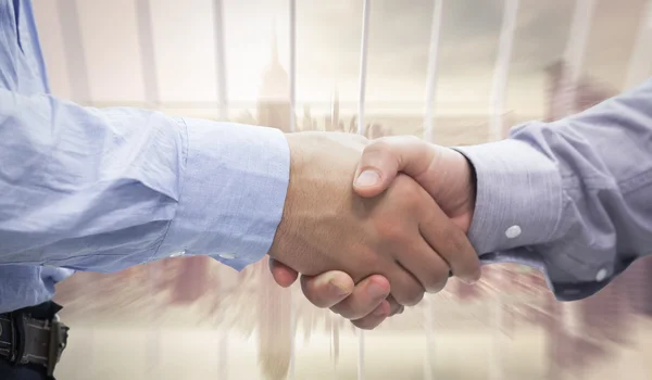 Men shaking hands against room with large window — Stock Photo, Image