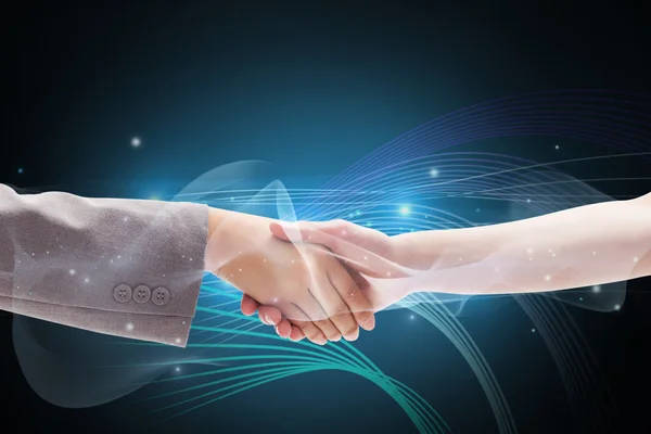 Composite image of handshake between two women — Stock Photo, Image