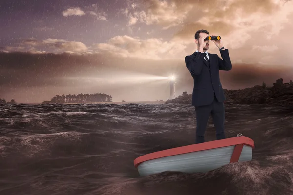 Businessman in boat with binoculars — Stock Photo, Image