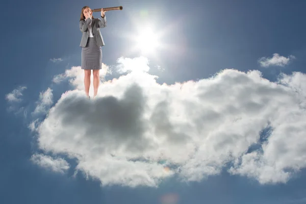 Businesswoman looking through a telescope — Stock Photo, Image