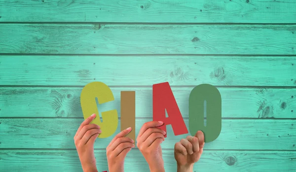 Hands holding up ciao against wooden planks — Stock Photo, Image