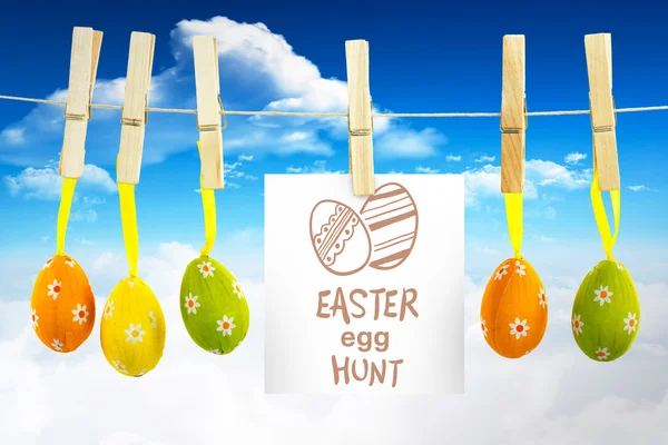 Easter eggs hunt graphic against clouds — Stock Photo, Image
