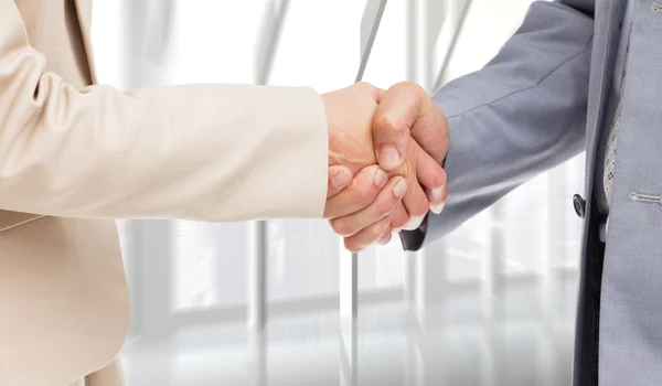 People shaking hands against room — Stock Photo, Image