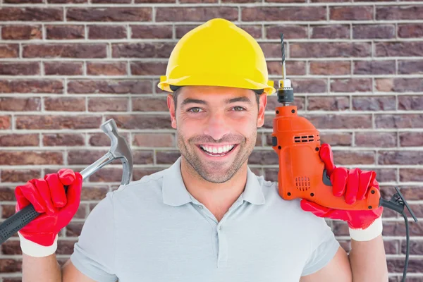 Repairman holding hammer and drill machine — Stock Photo, Image