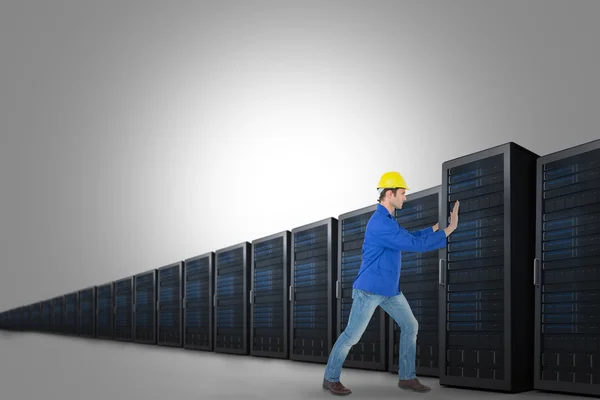 Male architect pushing server tower — Stock Photo, Image