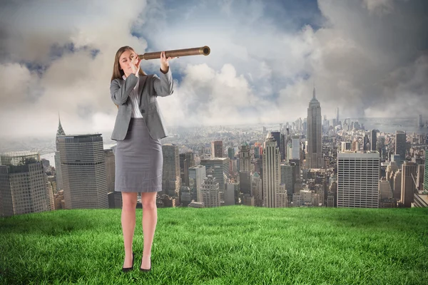 Businesswoman looking through a telescope — Stock Photo, Image