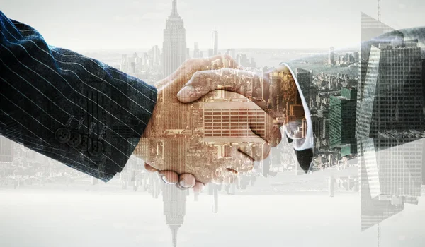 Business people shaking hands against window — Stock Photo, Image