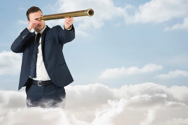 Imagen compuesta del hombre de negocios mirando a través del telescopio — Foto de Stock