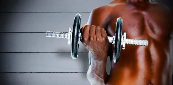 Shirtless man holding dumbbell — Stock Photo, Image